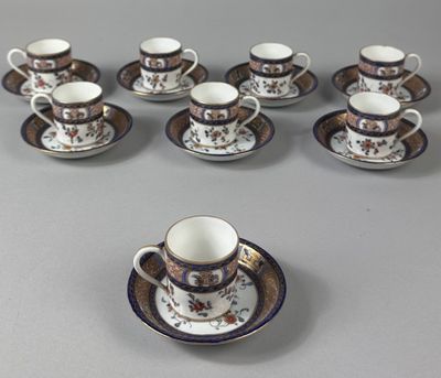 nine cups and saucers sitting on a table
