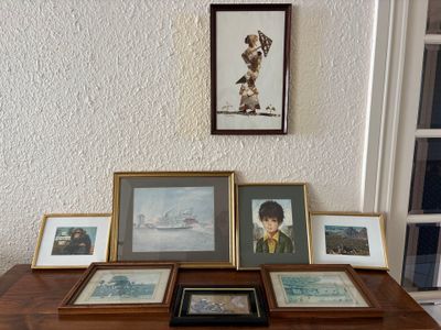 a table with pictures and pictures on it in front of a window