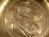 a gold plate with a picture of a man on it