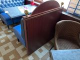a booth with a table and blue chairs in it