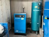 two blue tanks and a blue machine in a garage