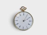 a gold pocket watch with roman numerals on the face