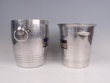 two silver cups sitting next to each other on a table