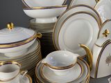 a lot of white and gold plates and cups and saucers