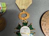 several medals and medals are displayed on a table next to a penny