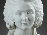 a white statue of a woman with long hair