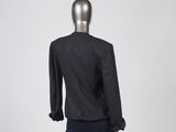 the back view of a mannequin wearing a black jacket and skirt