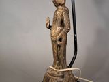 an image of a statue of a person holding a lamp