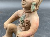 an image of a statue of a man with a cat in his lap