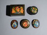three small decorative items are sitting on a table next to a box