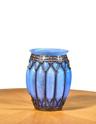 a blue vase sitting on top of a wooden table