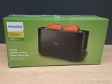 un grille-pain Philips contenant deux tranches de pain, posé sur une table