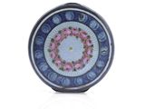 a blue and white plate with pink flowers on it