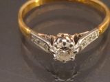a close up of a diamond ring on a table