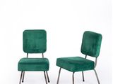 pair of green velvet chairs with metal legs and a green upholstered seat