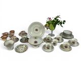 many different types of dishes and cups on the table