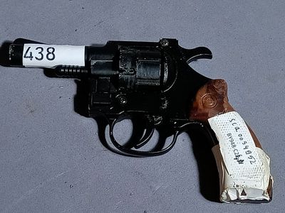a toy gun with a tag on it on a table