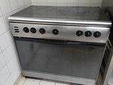a stainless steel stove in a kitchen with tile flooring