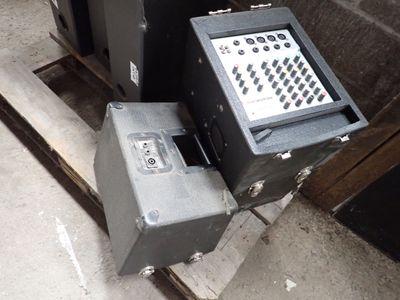 two black boxes sitting next to each other on a pallet