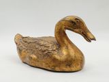 brass duck figurine on a white background