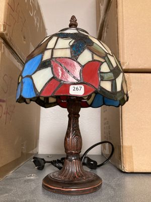 a lamp that is sitting on a table next to boxes