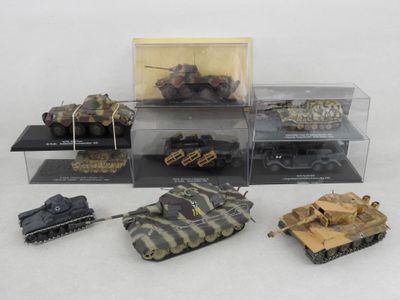 many different types of toy tanks in a display case