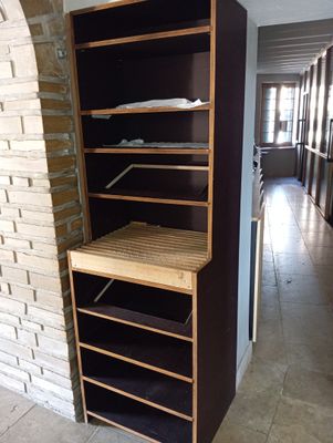 a shelf that has some clothes on it in a room