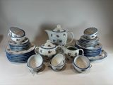 a lot of blue and white dishes and cups on the table