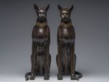 pair of bronze statues of a cat and a dog sitting side by side