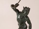 an image of a bronze statue of a man holding a spear