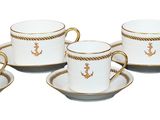 six cups and saucers sitting on a saucer