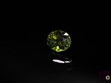 a close up of a green diamond on a black surface