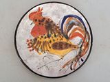 a plate with a painting of a rooster on it