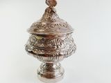 a silver container with a bird on top of it