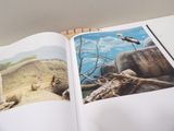 an open book with a picture of a bird on it