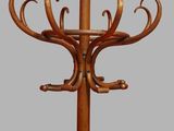 a wooden coat stand with a coat rack on top of it