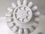 a close up of a white sink with a drainer