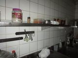 a kitchen with a sink and a counter with a lot of utensils on it
