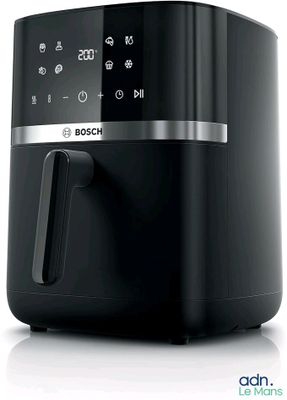 a close up of a black and silver air fryer on a white surface