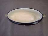 a black and white oval dish sitting on a table