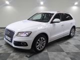 the white audi suv is parked on a checkered tile floor