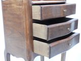 a wooden dresser with four drawers on it