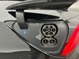 a close up of a car with an electric plugged in it