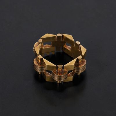 a close up of a gold ring on a black surface