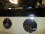 two round mirrors on the wall of a building