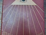 an old book on a wooden table with a picture of an eye