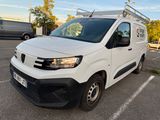 the white van is parked in a parking lot with other vehicles in the background