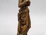a bronze statue of a woman holding a rosary