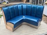 a blue couch that is sitting on a wooden platform