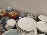 a lot of plates and bowls on the table